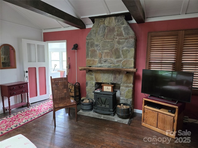 living room featuring a wood stove, vaulted ceiling with beams, and wood finished floors