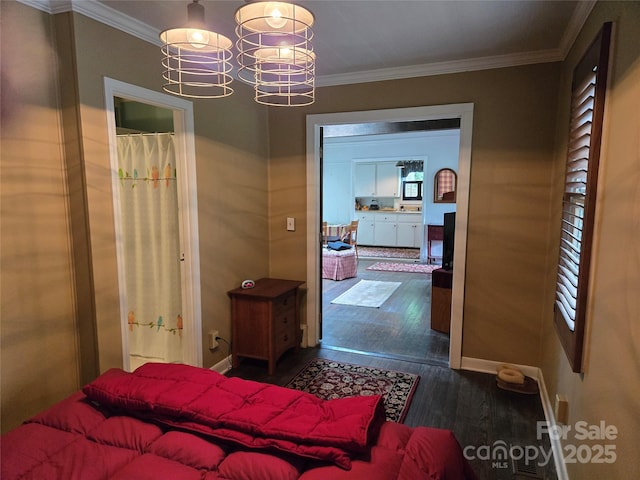 bedroom featuring a chandelier, crown molding, and dark wood finished floors