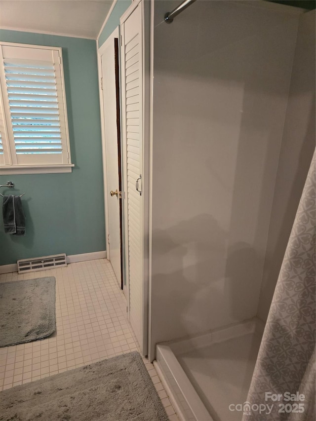 bathroom with a stall shower, tile patterned floors, and visible vents