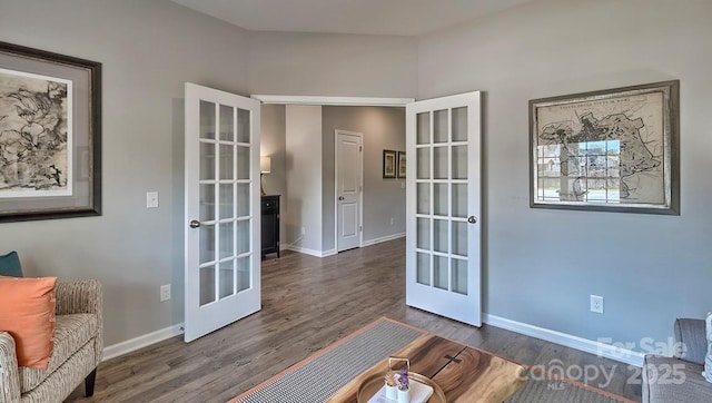 living area with baseboards, french doors, and wood finished floors