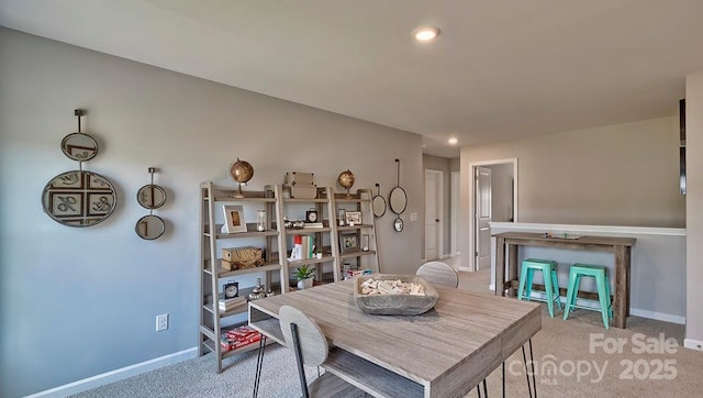dining space featuring light carpet, baseboards, and recessed lighting