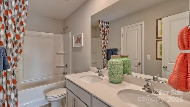 bathroom featuring a sink, double vanity, toilet, and shower / tub combo with curtain