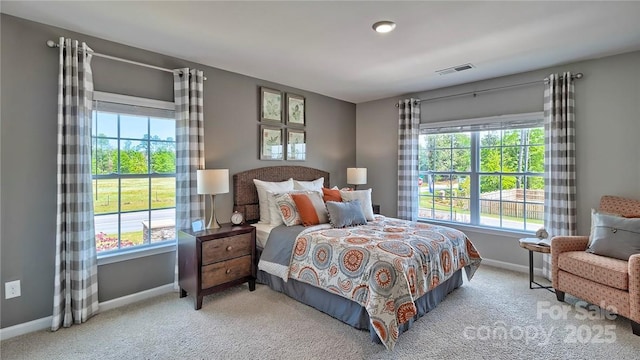 carpeted bedroom featuring visible vents and baseboards
