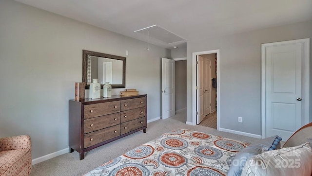 bedroom featuring baseboards, light carpet, and attic access