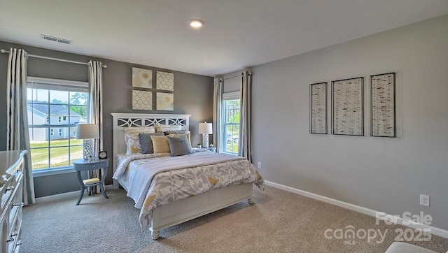 carpeted bedroom with baseboards and visible vents