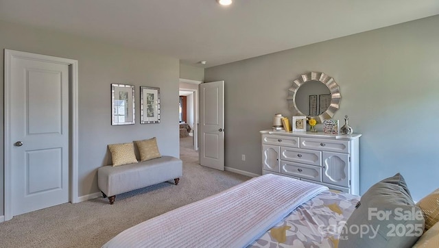 bedroom featuring light carpet and baseboards