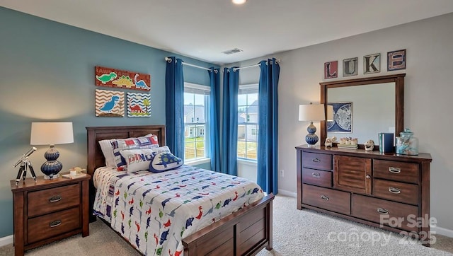 bedroom with baseboards, light carpet, and visible vents