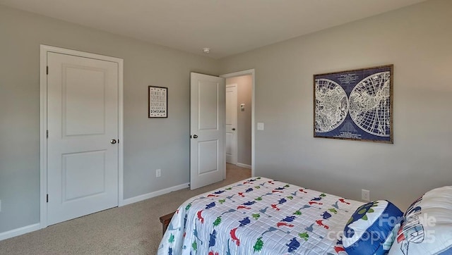 bedroom featuring carpet floors and baseboards