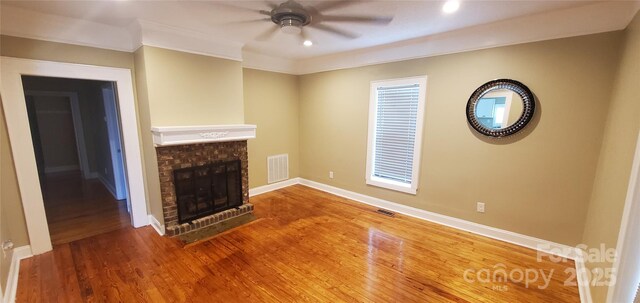 615 Grier St, Lincolnton, NC 28092 - unfurnished living room with a brick fireplace, ceiling fan, wood finished floors, baseboards, and recessed lighting