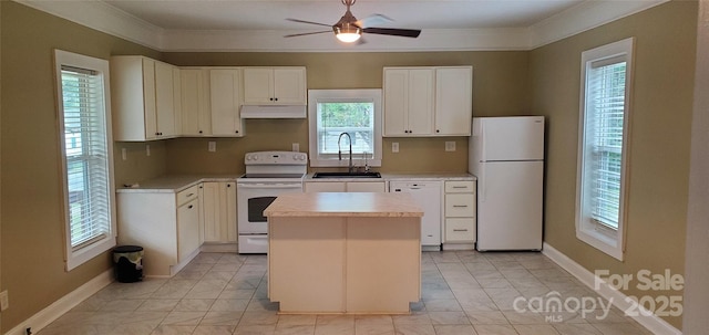 615 Grier St, Lincolnton, NC 28092 - kitchen featuring white appliances, a sink, under cabinet range hood, light marble finish floors, and a center island