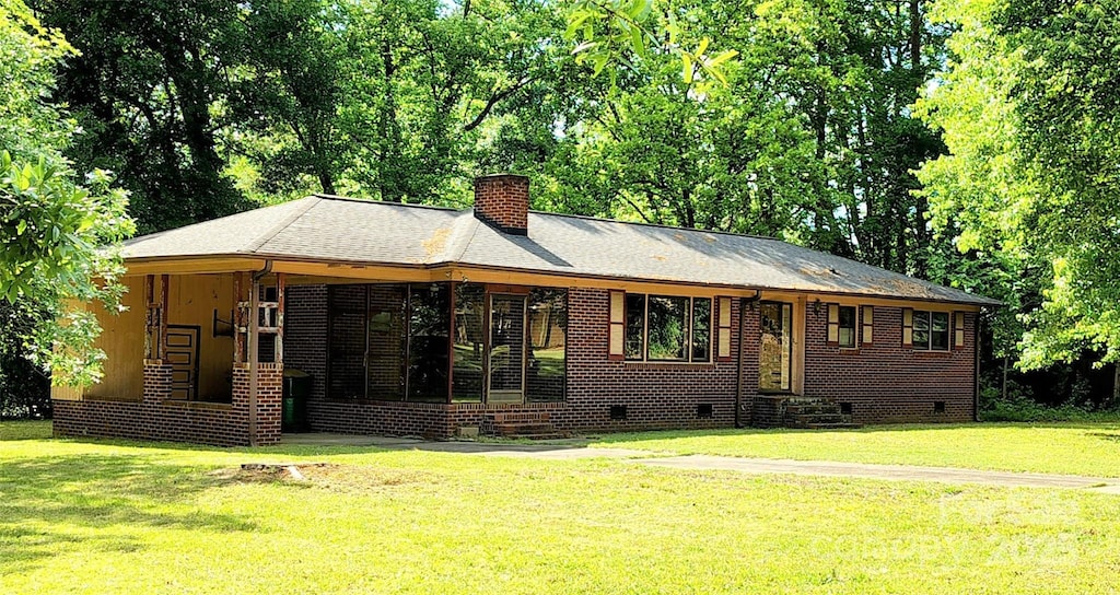 824 Kentberry Dr, Charlotte, NC 28214 - rear view of house with crawl space, a chimney, and a lawn