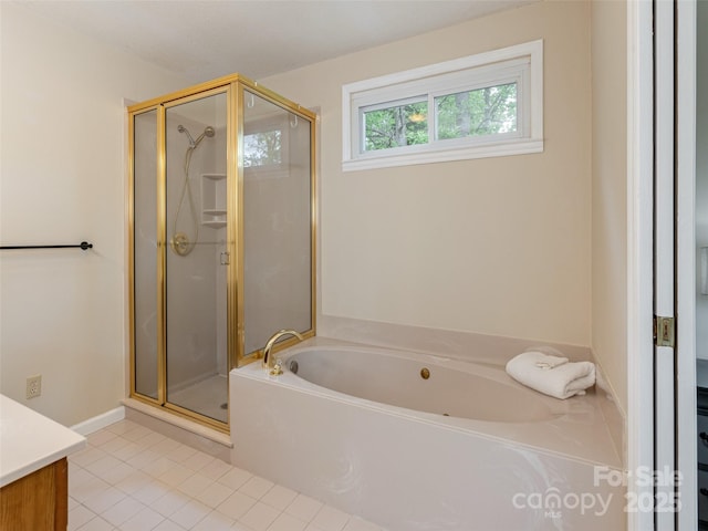 bathroom featuring a shower stall, a garden tub, tile patterned flooring, and vanity