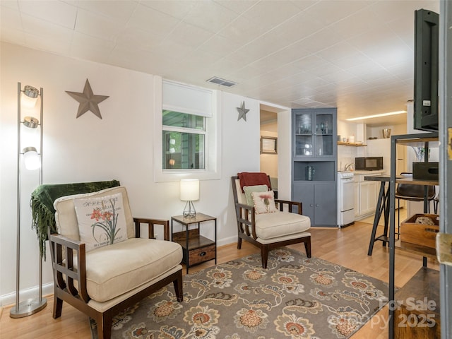 living area with light wood finished floors and baseboards