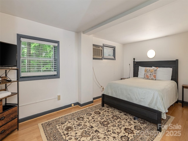 bedroom featuring wood finished floors and baseboards