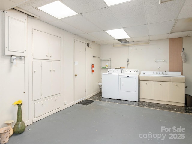 washroom featuring washing machine and dryer and cabinet space