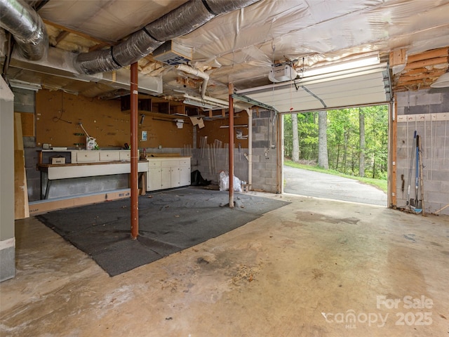 garage with a workshop area and a garage door opener