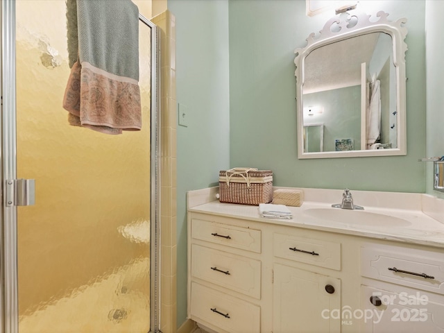 bathroom featuring a shower stall and vanity