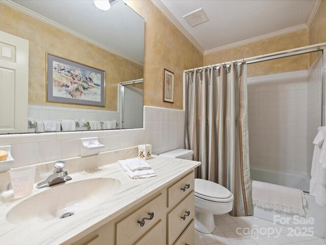bathroom with tile patterned flooring, a textured ceiling, shower / tub combo with curtain, toilet, and vanity