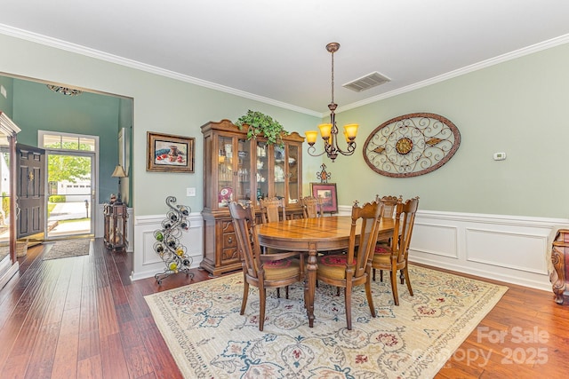 2035 Moultrie Ct, Fort Mill, SC 29707 - dining space with a chandelier, crown molding, wood-type flooring, and wainscoting
