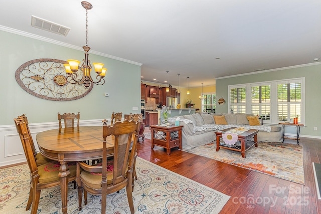 2035 Moultrie Ct, Fort Mill, SC 29707 - dining area featuring a chandelier, crown molding, and wood finished floors