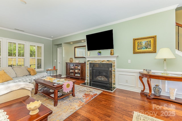 2035 Moultrie Ct, Fort Mill, SC 29707 - living area featuring crown molding, wood finished floors, and a glass covered fireplace