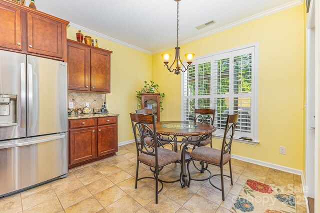 2035 Moultrie Ct, Fort Mill, SC 29707 - dining area with a chandelier, ornamental molding, and baseboards