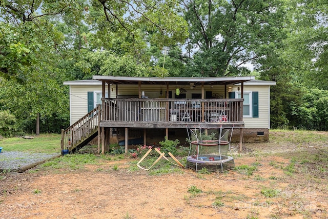 rear view of house featuring crawl space, stairs, and a wooden deck