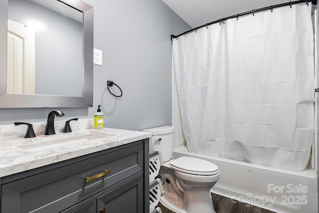 full bathroom featuring a textured ceiling, toilet, vanity, wood finished floors, and shower / tub combo