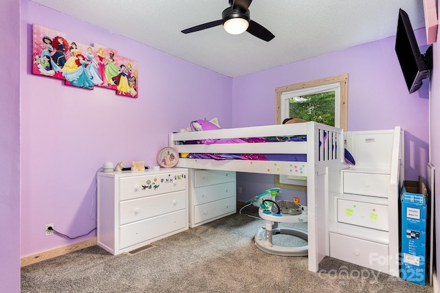 bedroom with carpet floors, a textured ceiling, and a ceiling fan