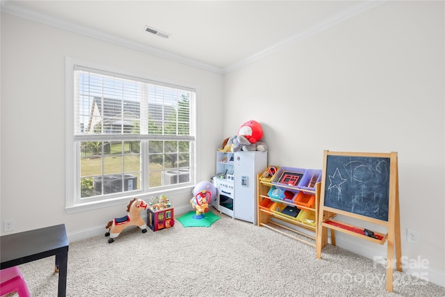 rec room with healthy amount of natural light, ornamental molding, carpet floors, and baseboards