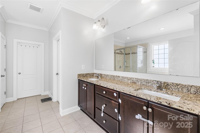 bathroom featuring a shower stall, baseboards, tile patterned floors, double vanity, and crown molding