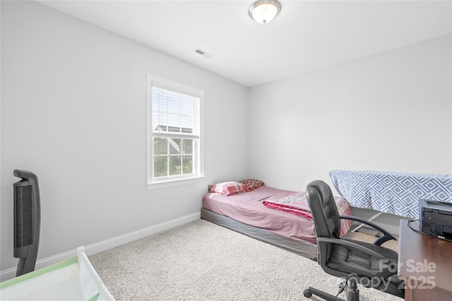 bedroom with baseboards and carpet