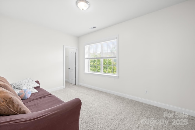 living area featuring baseboards and carpet