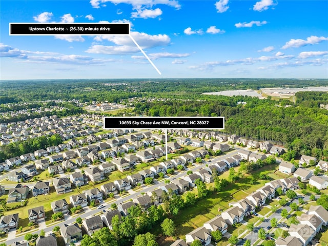 aerial perspective of suburban area with a forest