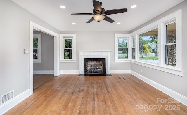 506 7th St SW, Hickory, NC 28602 - unfurnished living room with a fireplace with flush hearth, a ceiling fan, baseboards, wood finished floors, and recessed lighting