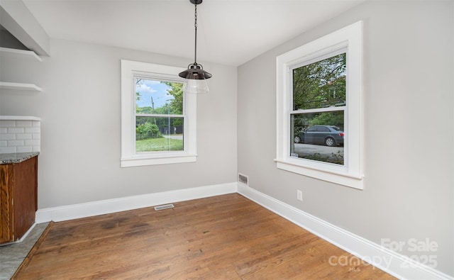 506 7th St SW, Hickory, NC 28602 - unfurnished dining area featuring wood finished floors and baseboards