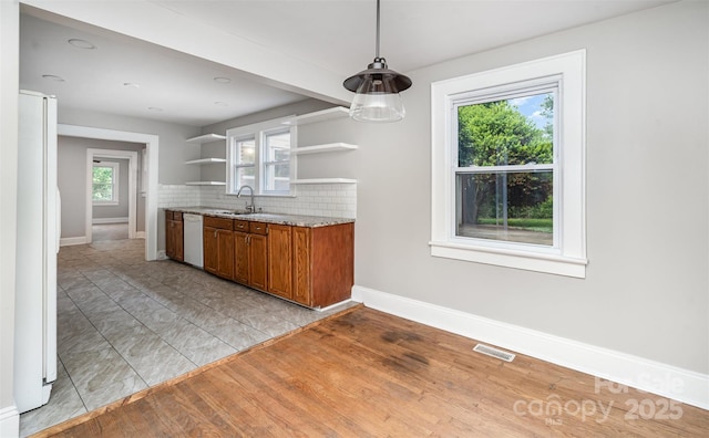 506 7th St SW, Hickory, NC 28602 - kitchen featuring white appliances, open shelves, brown cabinets, and baseboards