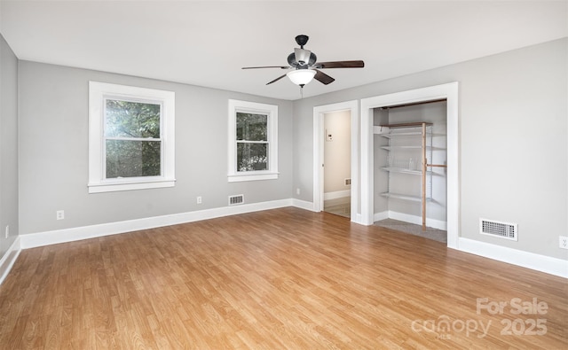 506 7th St SW, Hickory, NC 28602 - unfurnished bedroom featuring wood finished floors, baseboards, a ceiling fan, and a closet