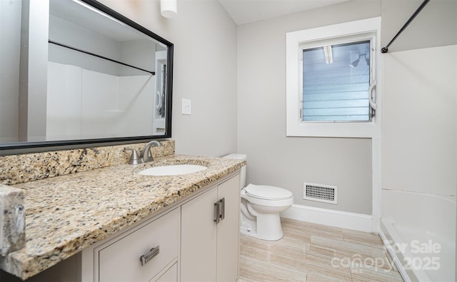 506 7th St SW, Hickory, NC 28602 - bathroom featuring baseboards, vanity, toilet, wood finished floors, and a shower