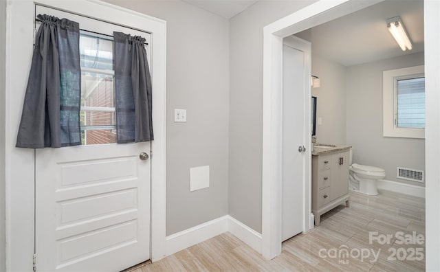506 7th St SW, Hickory, NC 28602 - bathroom featuring baseboards, vanity, and toilet