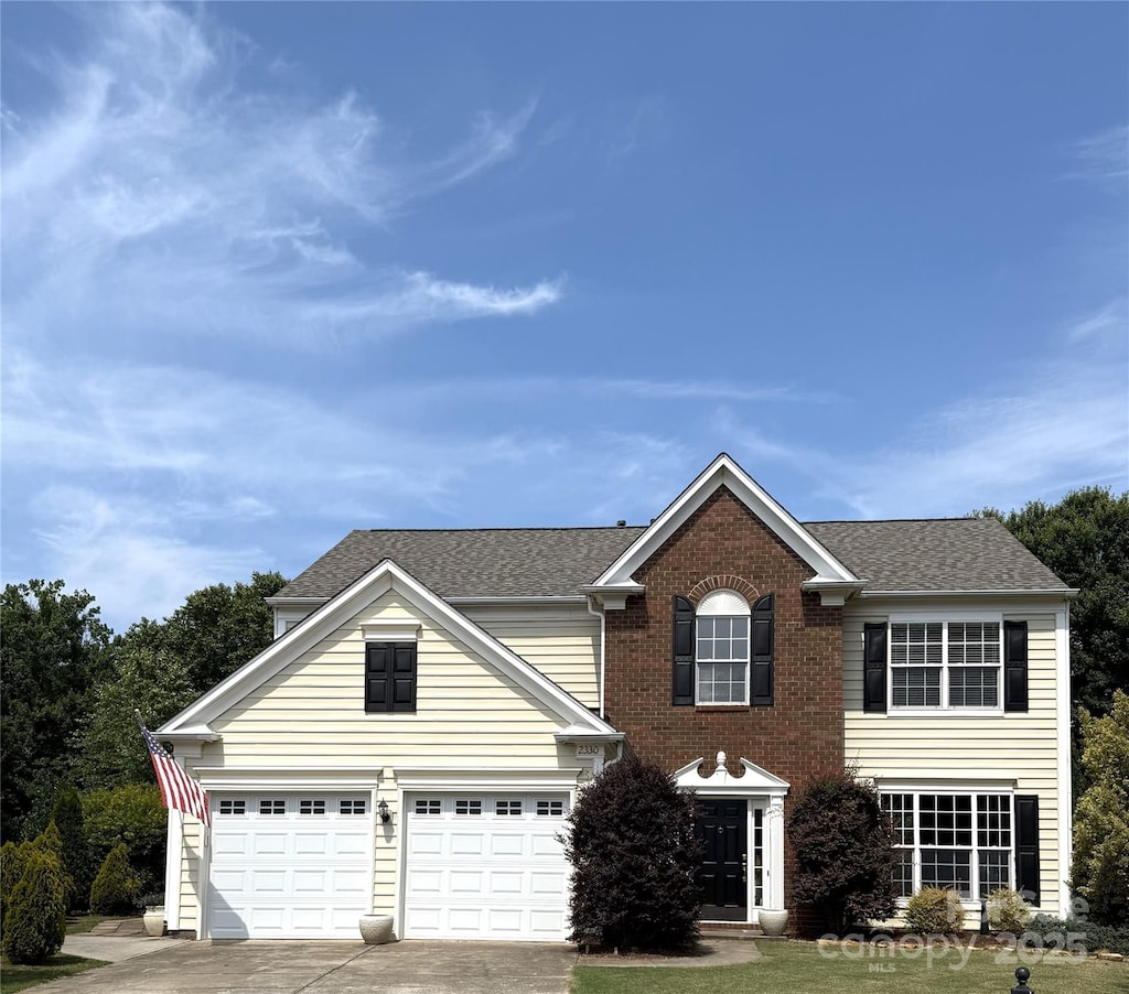 2330 Winthorp Ridge Rd, Charlotte, NC 28270 - view of front of house featuring driveway, a shingled roof, a garage, and brick siding