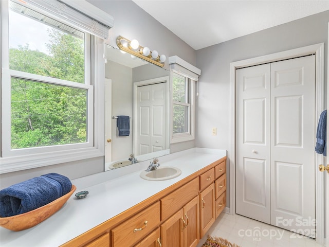 bathroom with vanity and a closet