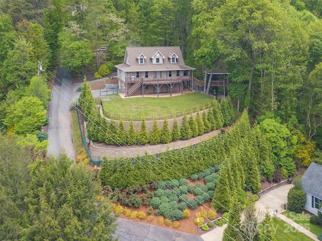 birds eye view of property with a view of trees