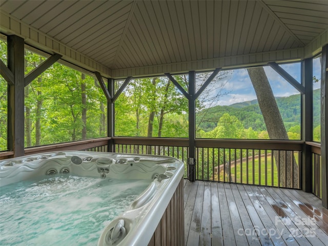 wooden terrace featuring a hot tub