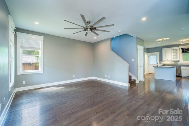 21 Bryant St, Asheville, NC 28806 - unfurnished living room featuring a ceiling fan, stairs, dark wood-type flooring, baseboards, and recessed lighting
