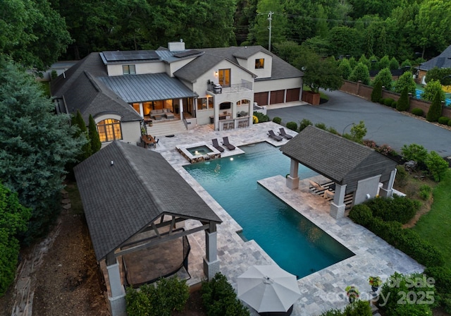 8300 Fairview Rd, Charlotte, NC 28226 - view of swimming pool featuring a patio, a view of trees, a pool with connected hot tub, and outdoor lounge area