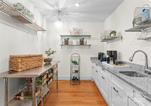 8300 Fairview Rd, Charlotte, NC 28226 - bar with a sink, light wood-type flooring, a chandelier, hanging light fixtures, and recessed lighting