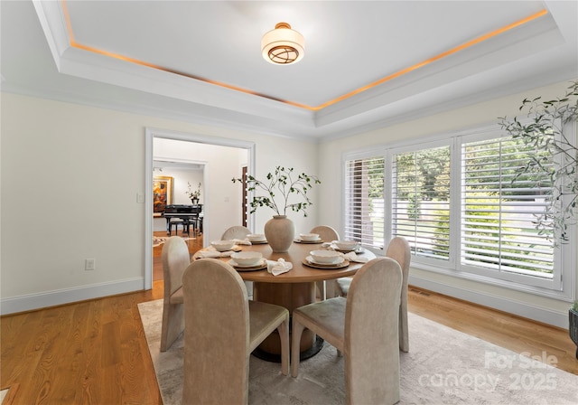 8300 Fairview Rd, Charlotte, NC 28226 - dining room with a raised ceiling, light wood-type flooring, baseboards, and ornamental molding