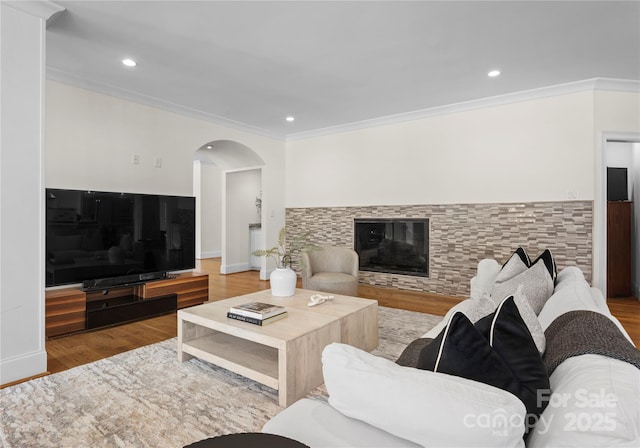 8300 Fairview Rd, Charlotte, NC 28226 - living area with arched walkways, crown molding, wood finished floors, recessed lighting, and a glass covered fireplace