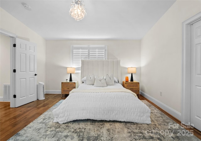 8300 Fairview Rd, Charlotte, NC 28226 - bedroom featuring baseboards, wood finished floors, and a chandelier